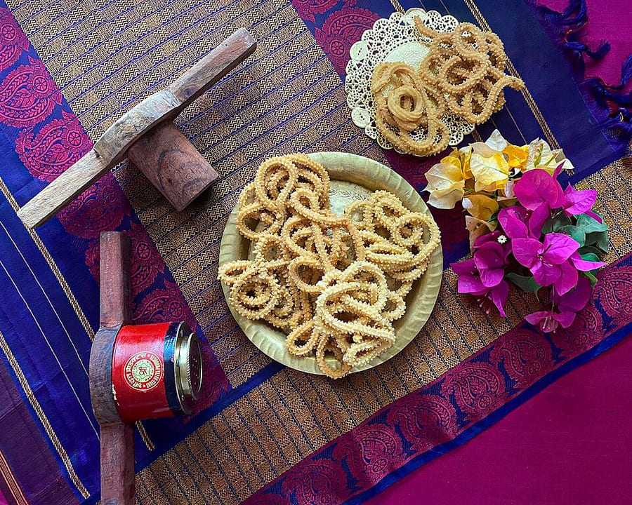 Venna murukulu served on a brass plate with flowers